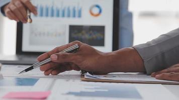 Financial analysts analyze business financial reports on a digital tablet planning investment project during a discussion at a meeting of corporate showing the results of their successful teamwork. video