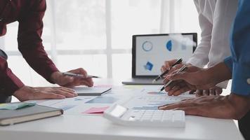 Financial analysts analyze business financial reports on a digital tablet planning investment project during a discussion at a meeting of corporate showing the results of their successful teamwork. video