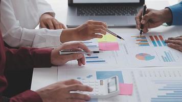 Financial analysts analyze business financial reports on a digital tablet planning investment project during a discussion at a meeting of corporate showing the results of their successful teamwork. video