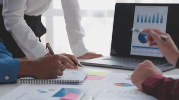 Financial analysts analyze business financial reports on a digital tablet planning investment project during a discussion at a meeting of corporate showing the results of their successful teamwork. video