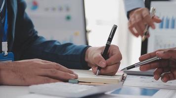 Financial analysts analyze business financial reports on a digital tablet planning investment project during a discussion at a meeting of corporate showing the results of their successful teamwork. video