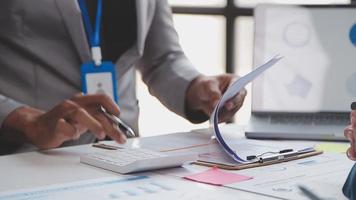 Financial analysts analyze business financial reports on a digital tablet planning investment project during a discussion at a meeting of corporate showing the results of their successful teamwork. video