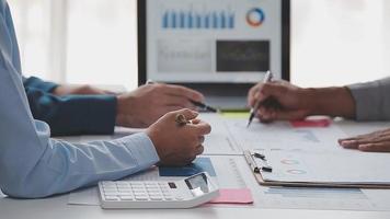 Financial analysts analyze business financial reports on a digital tablet planning investment project during a discussion at a meeting of corporate showing the results of their successful teamwork. video