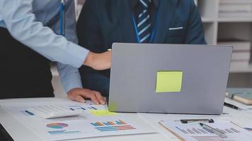 Financial analysts analyze business financial reports on a digital tablet planning investment project during a discussion at a meeting of corporate showing the results of their successful teamwork. video