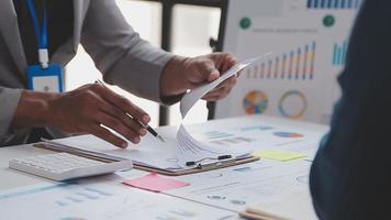 Financial analysts analyze business financial reports on a digital tablet planning investment project during a discussion at a meeting of corporate showing the results of their successful teamwork. video