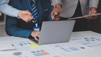 Financial analysts analyze business financial reports on a digital tablet planning investment project during a discussion at a meeting of corporate showing the results of their successful teamwork. video