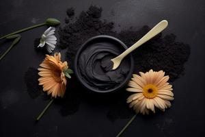 Chocolate face mask in a black bowl with flowers on a black background photo