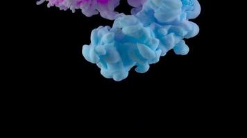 Color drop underwater creating a silk drapery. Ink swirling underwater. Reverse shooting video