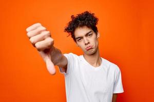 Cheerful guy in white t-shirt hand gesture emotions Studio photo