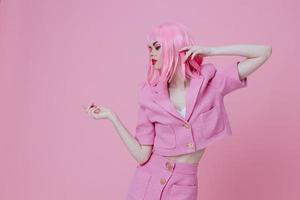 Beautiful fashionable girl in a pink suit gesturing with his hands emotions fun Studio Model unaltered photo