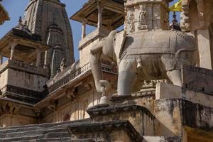 statue of elephant holding bell in ancient temple near Jaipur, India photo