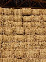 close up of stacks of hay bales background photo