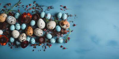 Banner of Easter quail eggs, and flowers over blue background - photo