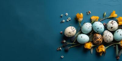 Banner of Easter quail eggs, and flowers over blue background - photo