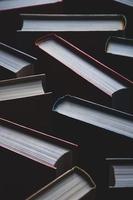 Background of books in hardcovers, full-frame texture, vertical shot photo