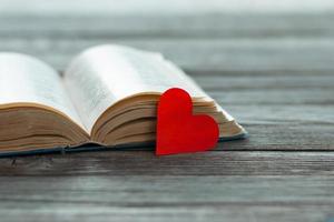 open book with red paper heart photo