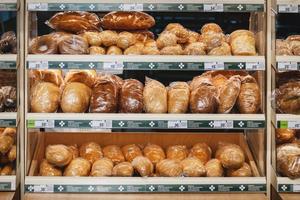 Various kinds of fresh bread in plastic packages for sale on supermarket shelves, Moscow, 28 Oct 2021 photo