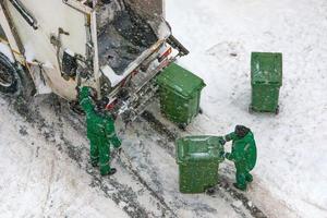 Garbage collection in winter snowy weather photo