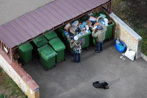 Homeless people digging trash cans, Moscow, 28.10.2019 photo