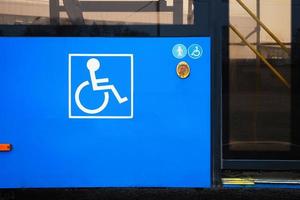 Public transport for all passengers, disabled person sign on city bus photo