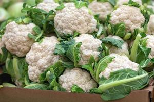 closeup of picked cauliflower in cardboard box in grocery store photo