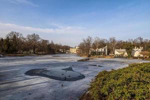 landscape with a palace on the water in Warsaw, Poland early spring on a sunny day with melting snow photo