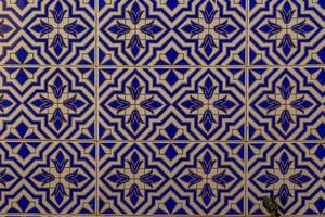 background of white-blue ceramic tiles with classic spanish patterns photo