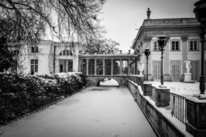 historic palace on the water in  park in Warsaw, Poland during snowy winter photo