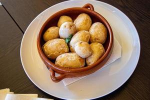 tasty healthy Canarian potatoes served in a retro vintage pot on the island of Gran Canaria photo