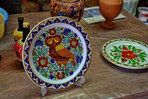 handmade clay dishes in the Greek style in the shop at the potter's workshop photo