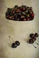 l juicy fresh summer cherries in a white bowl on a vintege background photo