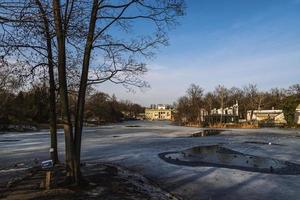 landscape with a palace on the water in Warsaw, Poland early spring on a sunny day with melting snow photo