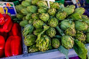 green Spanish artichokes healthy on a market stand photo