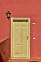 old vintage entrance door on the background of red wall photo