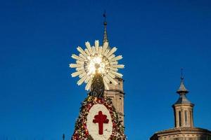 Christian celebration in Zaragoza, Spain, in the Octernik firga in flowers against the sky photo