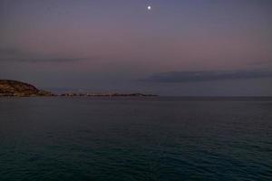 sunset landscape of alicante spain with moon photo