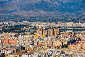 view on a sunny day of the city and colorful buildings from the viewpoint Alicante Spain photo