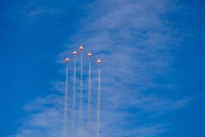 flight of five cessna planes over alicante smoke spanish flag against the blue sky photo