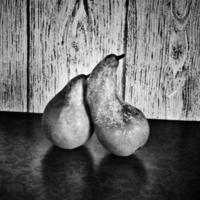 still life with pears on a wooden background photo