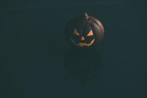 chocolate halloween pumpkin jack-o-lantern on dark background photo