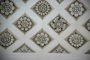 vintage background from a gray ceiling with gypsum gypsum flowers photo