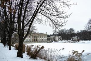 historic palace on the water in park in Warsaw, Poland during snowy winter photo