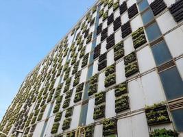 View of the Facade of multi storey parking building, green building, Jakarta, Indonesia - March 20th, 2023 photo