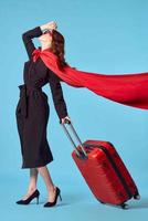 Business woman in black coat luggage travel passenger photo