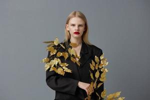 portrait of a woman decorations black jacket golden leaves studio model unaltered photo
