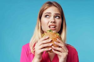 cheerful blonde fast food snack emotion blue background photo