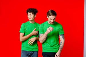 two men green t-shirt communication studio team photo