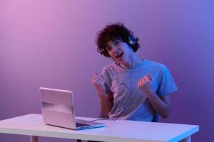 man sitting at the table gaming laptop isolated background photo