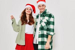 merry man and woman are standing next to christmas hats christmas eve holiday photo