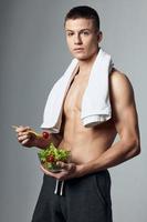 athletic guys with a plate of salad healthy food towel on shoulders energy photo